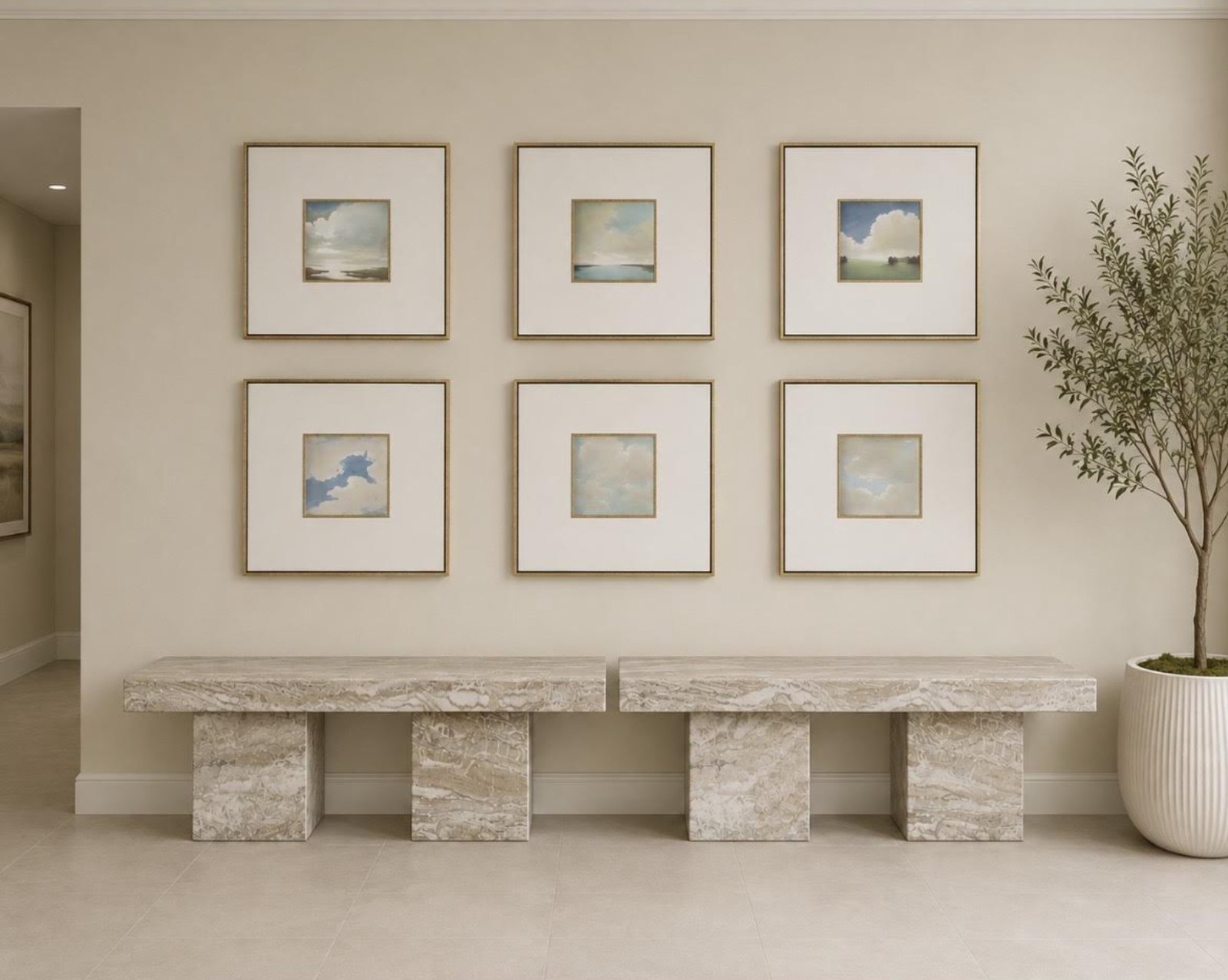 A calm interior corridor at Hamptons Endoscopy Center with coastal cloud artwork and natural stone benches
